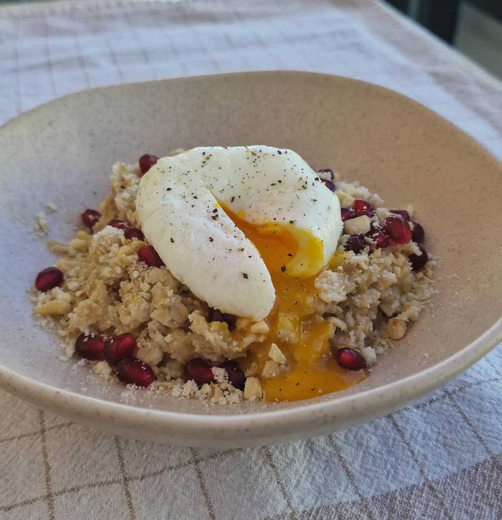 Savory Oatmeal with a Poached Egg, Parmesan cheese, pomegranate seeds