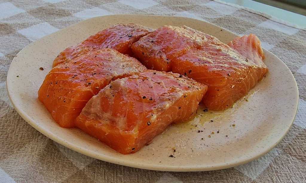 salmon filet covered with salt pepper olive oil