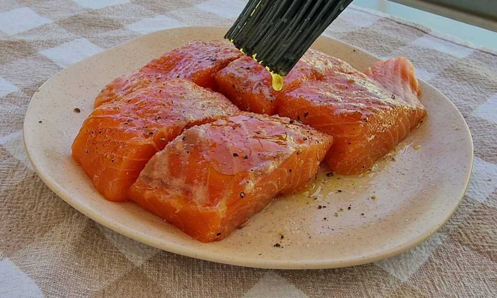 salmon filet covered with salt pepper olive oil