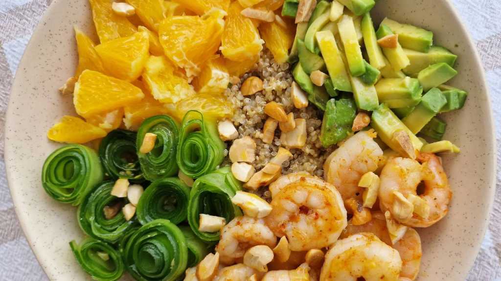 Quinoa bowl with shrimp, oranges, avocado, and cucumbers recipe