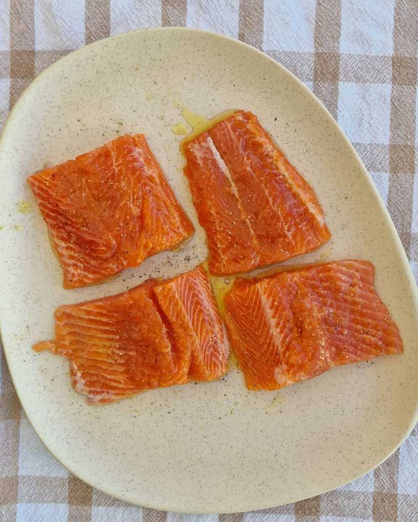 salmon fillets seasoned with salt, pepper, garlic, olive oil