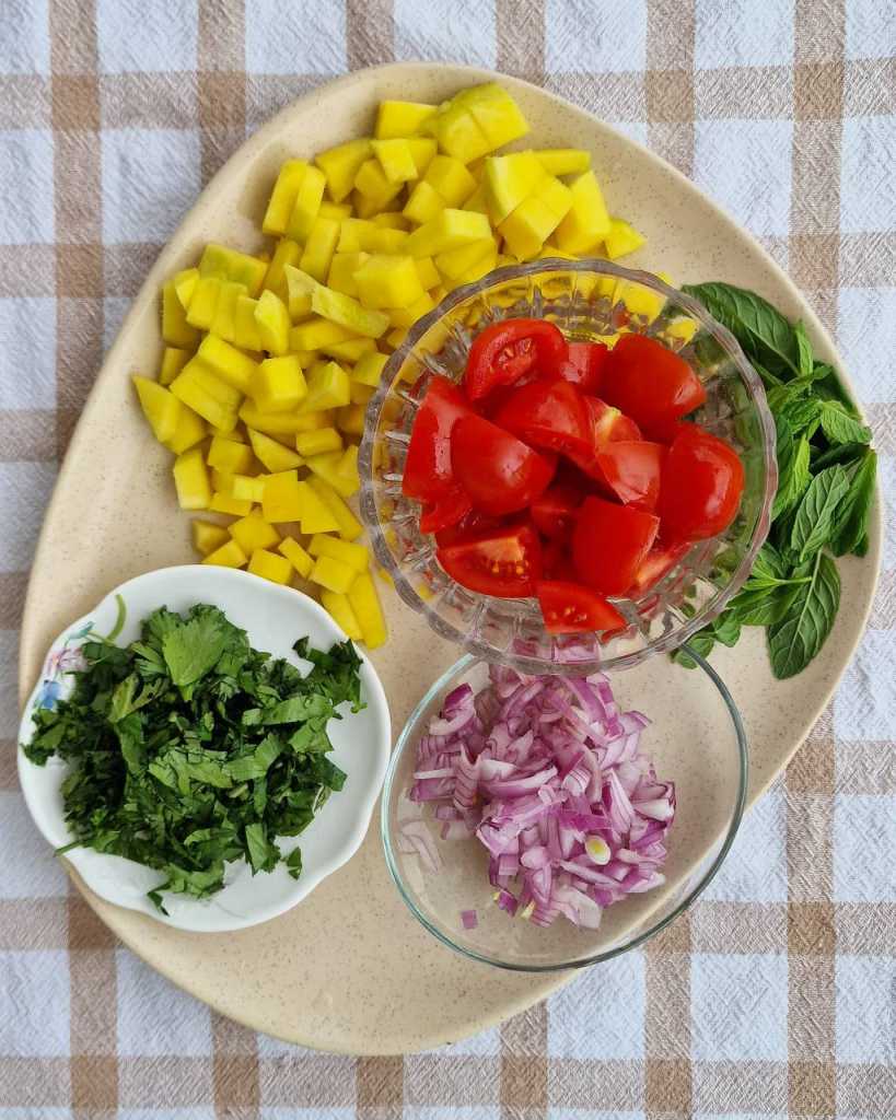 Mango, red onion, cilantro, mint, cherry tomatoes for Mango Quinoa Salad recipe