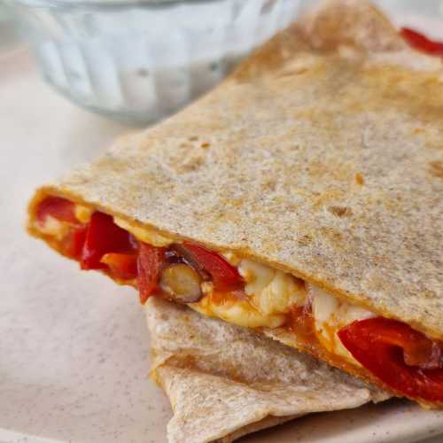 vegetarian quesadilla with bell peppers, beans and cheese