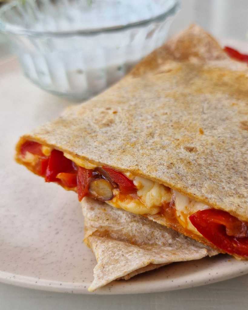 vegetarian quesadilla with bell peppers, beans and cheese