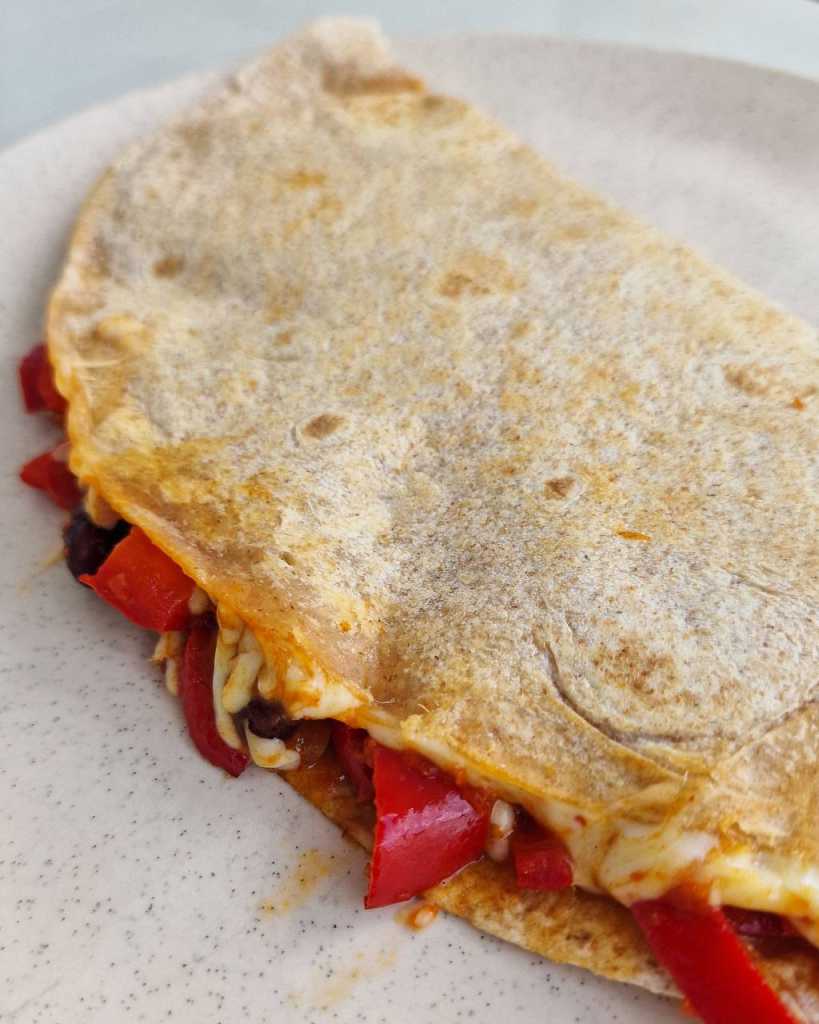 vegetarian quesadilla with bell peppers, beans and cheese