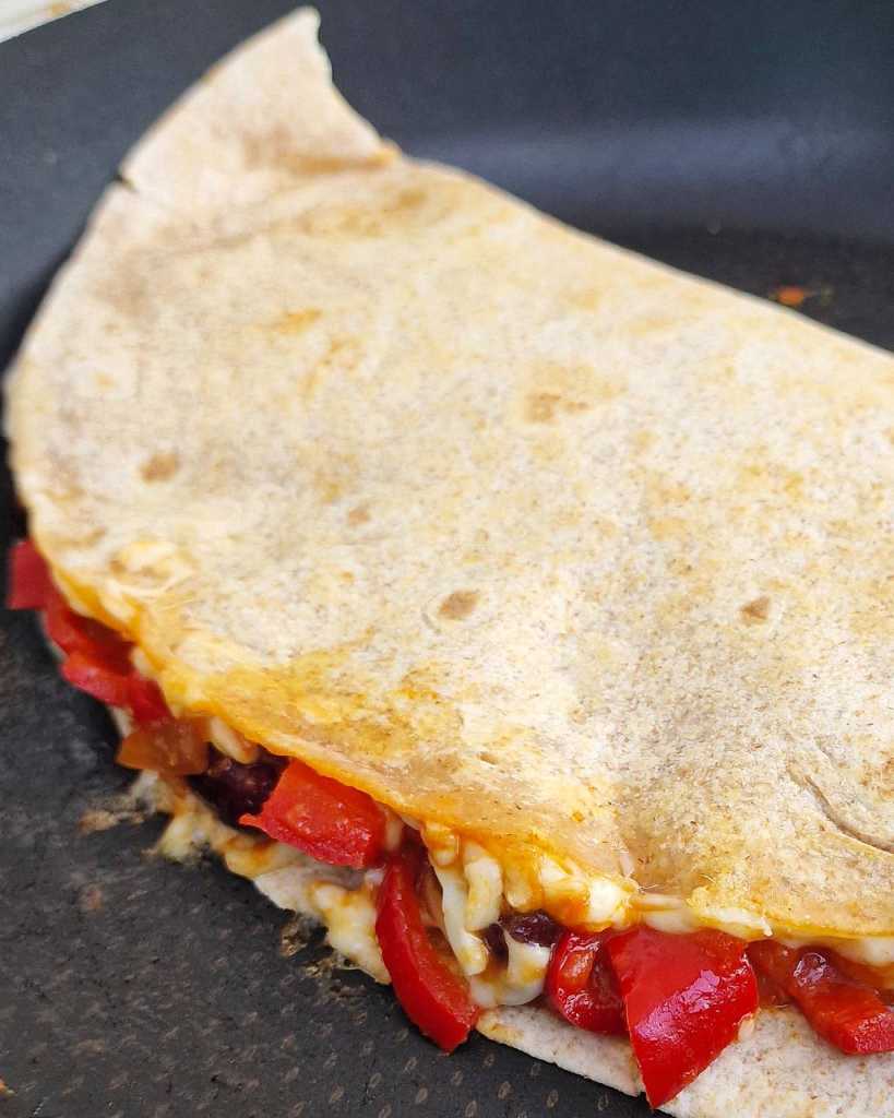 vegetarian quesadilla with bell peppers, beans and cheese