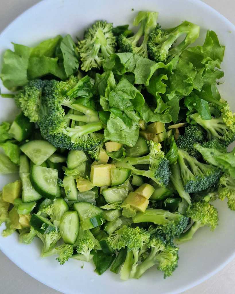 mixed greens, broccoli florets, avocado and cucumber for Green Goddess Salad